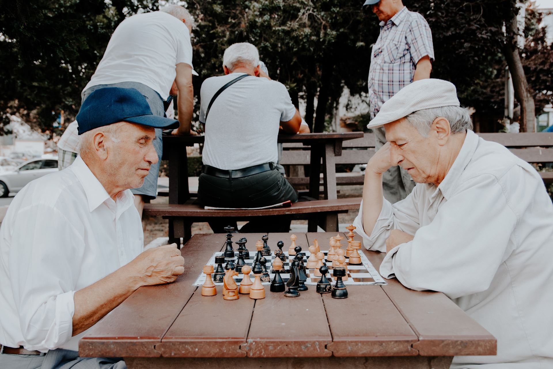 two elderly people playing chess